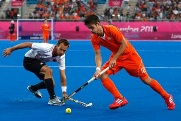 Germany's Matthias Witthaus (L) challenges Netherlands' Robbert Kemperman during their men's gold medal hockey match at the Riverbank Arena at the London 2012 Olympic Games August 11, 2012. REUTERS