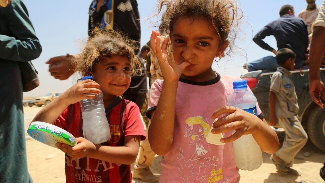 Two girls and other displaced civilians, who fled their ISISheld towns and villages south of Mosul during fighting between Iraqi security forces and Islamic State militants, arrive to a camp for displaced outside Irbil, 217 miles (350 kilometers) north of Baghdad, Iraq. (File Photo: AP)