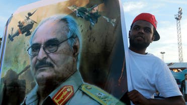 A man holds a picture of General Khalifa Haftar during a demonstration in support of the Libyan army under the leadership of General Khalifa in Benghazi, Libya November 6, 2015. (Reuters)