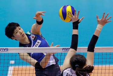 Miyu Nagaoka of Japan spikes against Park Jeong-ah of South Korea during their Women's Volleyball World Olympic Qualification Tournament in Tokyo, Tuesday, May 17, 2016. (AP)