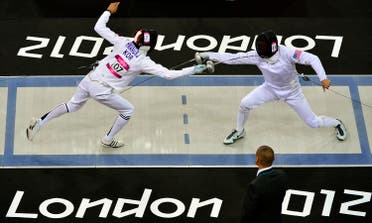 South Korea's Hwang Woojin (L) competes against Dennis Bowsher of the U.S. during the fencing event of the men's modern pentathlon during the London 2012 Olympics at the Copper Box August 11, 2012. REUTERS/Toby Melville (BRITAIN - Tags: SPORT OLYMPICS PORT MODERN PENTATHLON SPORT FENCING)