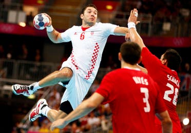 Croatia's Blazenko Lackovic scores against Hungary during their men's bronze medal handball match during the London 2012 Olympic Games at the Basketball Arena August 12, 2012. REUTERS