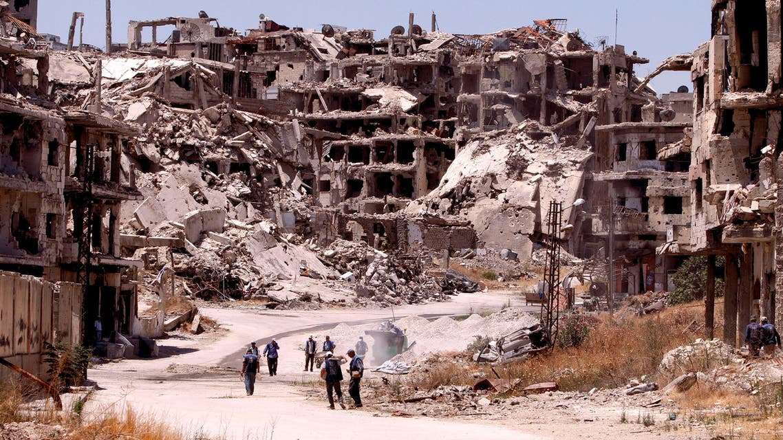 Workers collect the rubble of damaged buildings to be recycled and reused for reconstruction, under the supervision of the United Nations Development Programme (UNDP) in the government-controlled district of Wadi al-Sayeh in Homs, Syria July 19, 2016. (Reuters)