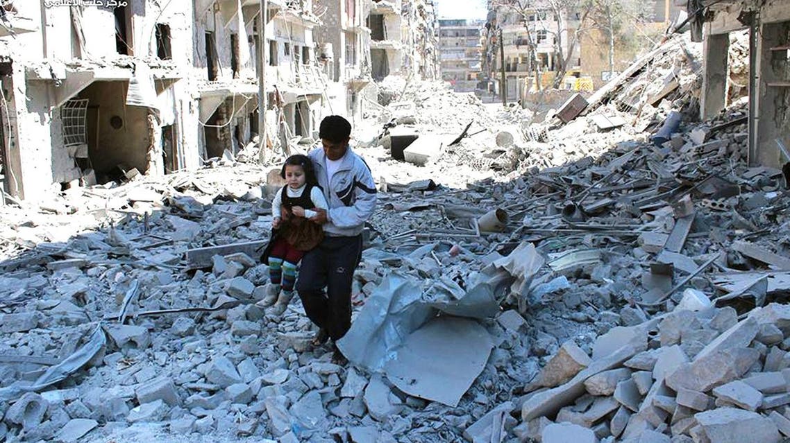 In This April 21, 2014 photo, provided by the anti-government activist group Aleppo Media Center (AMC), a Syrian man holding a girl as he stands on the rubble of houses that were destroyed by Syrian government forces air strikes in Aleppo. (AP)