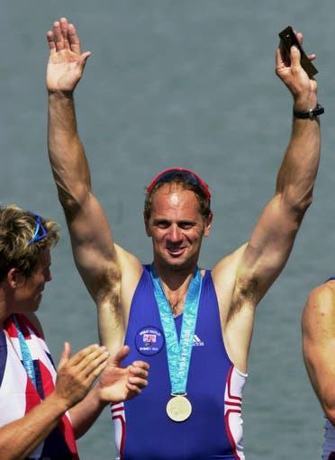 Steven Redgrave acknowledges the crowd after receiving a special gold pin Saturday, Sept. 23, 2000, at the Sydney International Regatta Center in Penrith, Australia. He received the pin in honor of winning five consecutive gold medals. Looking on at left is teammate James Cracknell. (AP)