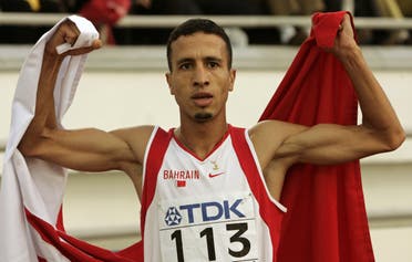 Rashid Ramzi of Bahrain holds the national flag after winning the men's 800 metres final at the world athletics championships in Helsinki August 14, 2005. (Reuters)