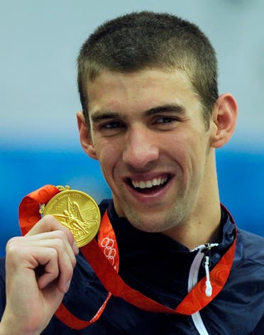 Michael Phelps displaying his eighth gold medal after the men's 4x100-meter medley relay final at the Beijing 2008 Olympics in Beijing. (AP)