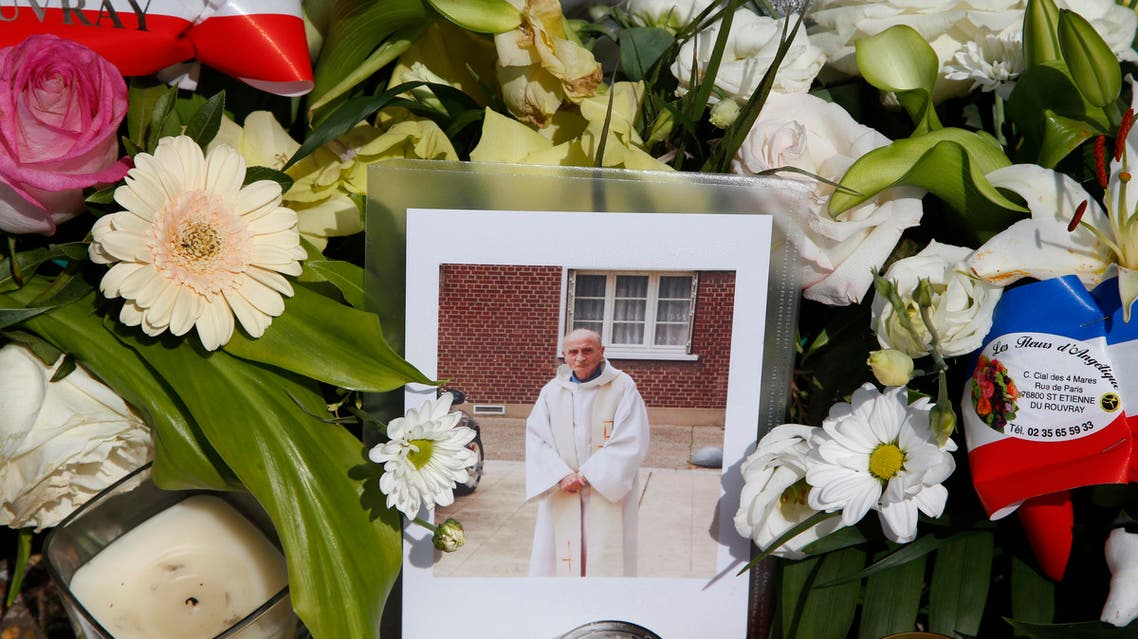 Flowers pay tribute to French priest Father Jacques Hamel outside the city hall in Saint-Etienne-du-Rouvray, near Rouen, France, July 28, 2016. Father Jacques Hamel was killed on Tuesday in an attack on the church that was carried out by assailants linked to ISIS. REUTERS