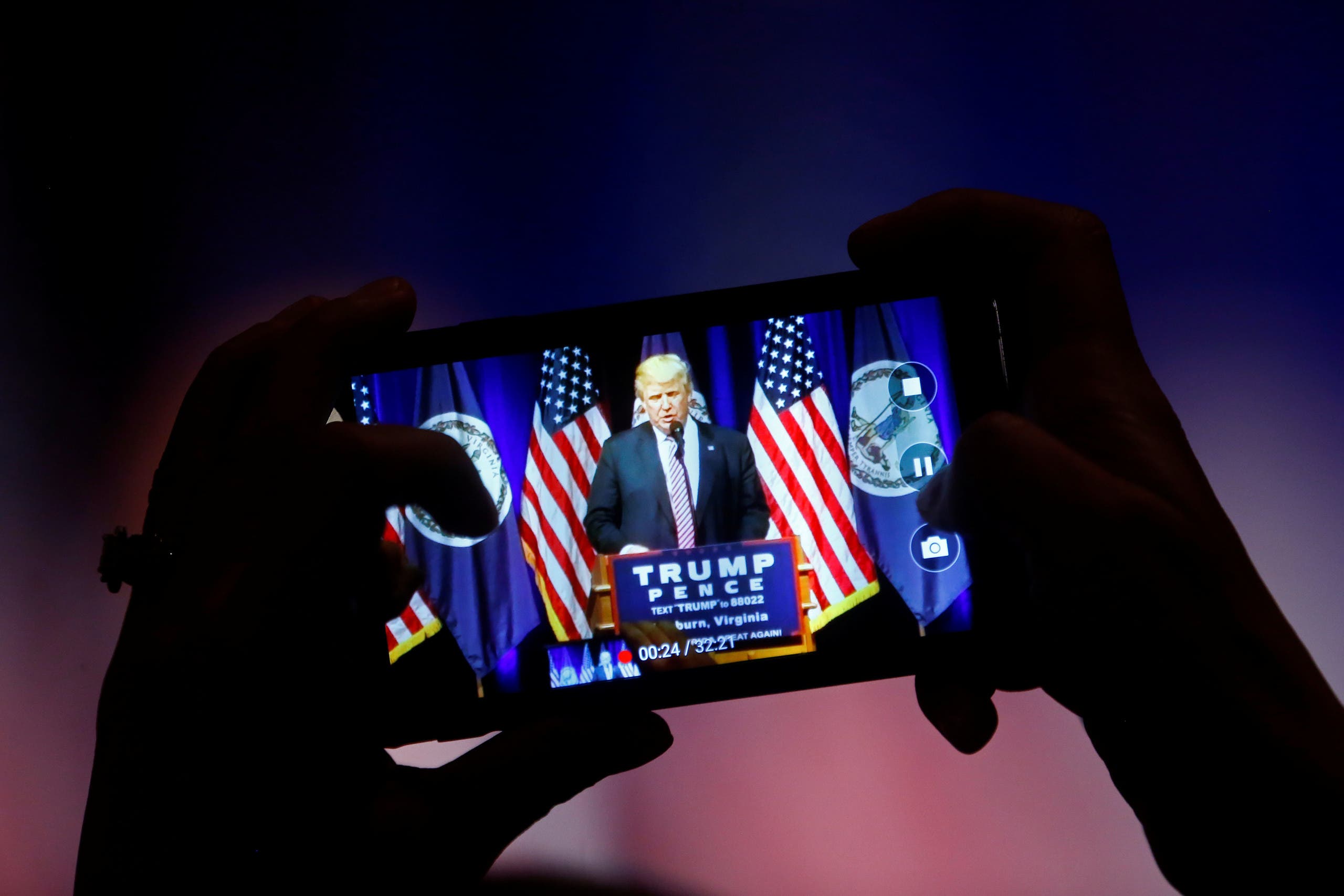 A supporter photographs Republican U.S. Presidential nominee Donald Trump during a campaign event at Briar Woods High School in Ashburn, Virginia, U.S., August 2, 2016. (Reuters)