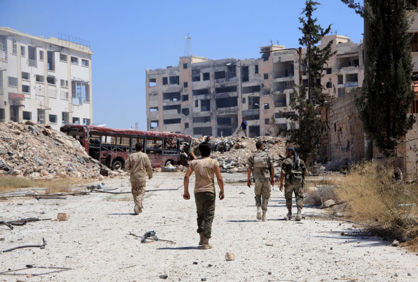 Syrian army soldiers patrol the area around the entrance of Bani Zeid after taking control of the previously rebel-held district of Leramun, on the northwest outskirts of Aleppo, on July 28, 2016. AFP