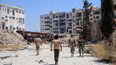 Syrian army soldiers patrol the area around the entrance of Bani Zeid after taking control of the previously rebel-held district of Leramun, on the northwest outskirts of Aleppo, on July 28, 2016. AFP