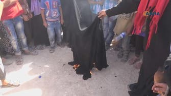 Syrian women burn burqas after liberation of Manbij from ISIS