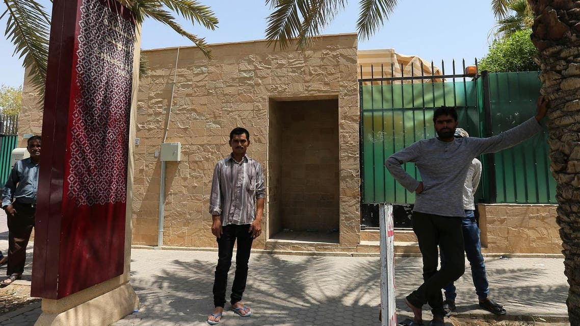 People stand in front of the Indian embassy in the Saudi capital Riyadh on August 2, 2016. New Delhi was working to feed more than 10,000 Indian labourers stranded in the Gulf with no wages after losing their jobs, in what Foreign Minister Sushma Swaraj called a "food crisis". Indians are among millions of poor Asians working in the Gulf states where human rights groups say many suffer exploitation and abuses including non-payment of wages, with no channels for redress. STRINGER / AFP
