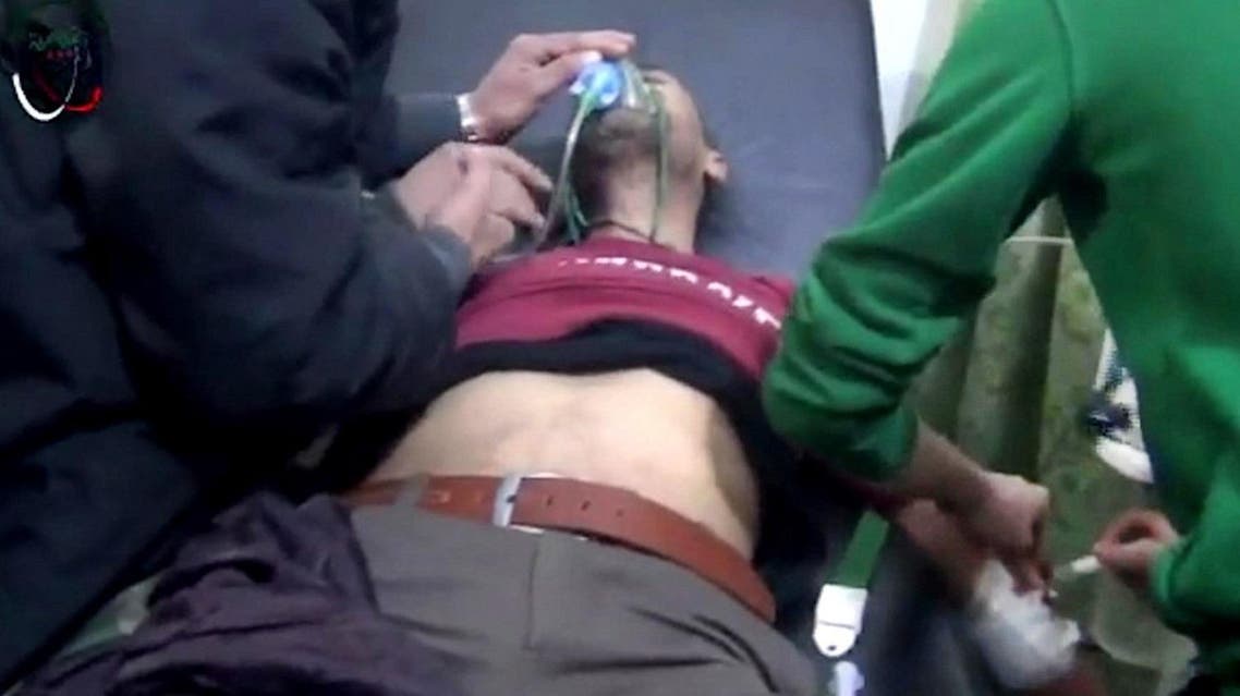 This image made from video made available by the Media Centre in Moadamiyat al-Sham on Wednesday, Dec. 23, 2015, shows a medic helping a patient at a town clinic, after an attack, in Moadamiyeh, southwest of Damascus, Syria. Syrian government forces on Wednesday attacked a rebel-held town southwest of Damascus with artillery fire and helicopters dropped barrel bombs as opposition groups accused the government of using poison gas in an assault there the previous night. (Media Centre in Moadamiyat al-Sham via AP)