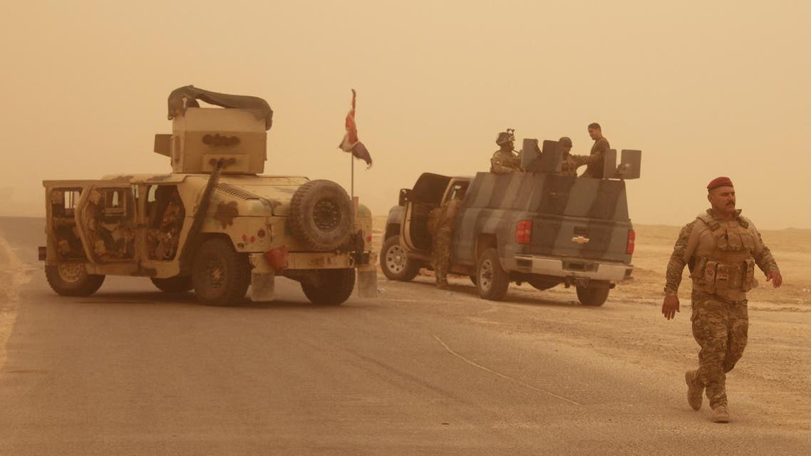 Iraqi government forces are seen on June 16, 2016 after recapturing the town of Zankura, northwest of Ramadi in Anbar province, from the Islamic State (IS) jihadist group, after IS fighters attacked positions in the area, including Zankoura, that were retaken by Iraqi forces earlier this year. According to Iraqi officers, retaking the area around Zankoura was an attempt by IS to distract Iraqi forces in Anbar province, where a big battle to retake Fallujah is going on. Fallujah is a medium-sized, densely built-up town that lies only 50 kilometres (30 miles) west of Baghdad. It is one of the last two major Iraqi cities IS controls, the other being Mosul.