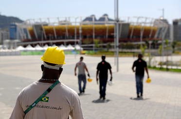 Construction workers walk inside Olympic Park as preparations take place for the 2016 Rio de Janeiro Games in Rio de Janeiro, Brazil, Wednesday, July 27, 2016. (AP)
