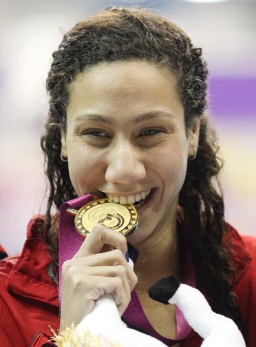 Farida Osman of Egypt celebrates after winning the gold medal at the Women's 100m Freestyle final at the Arab Games in Doha December 21, 2011. (Reuters)