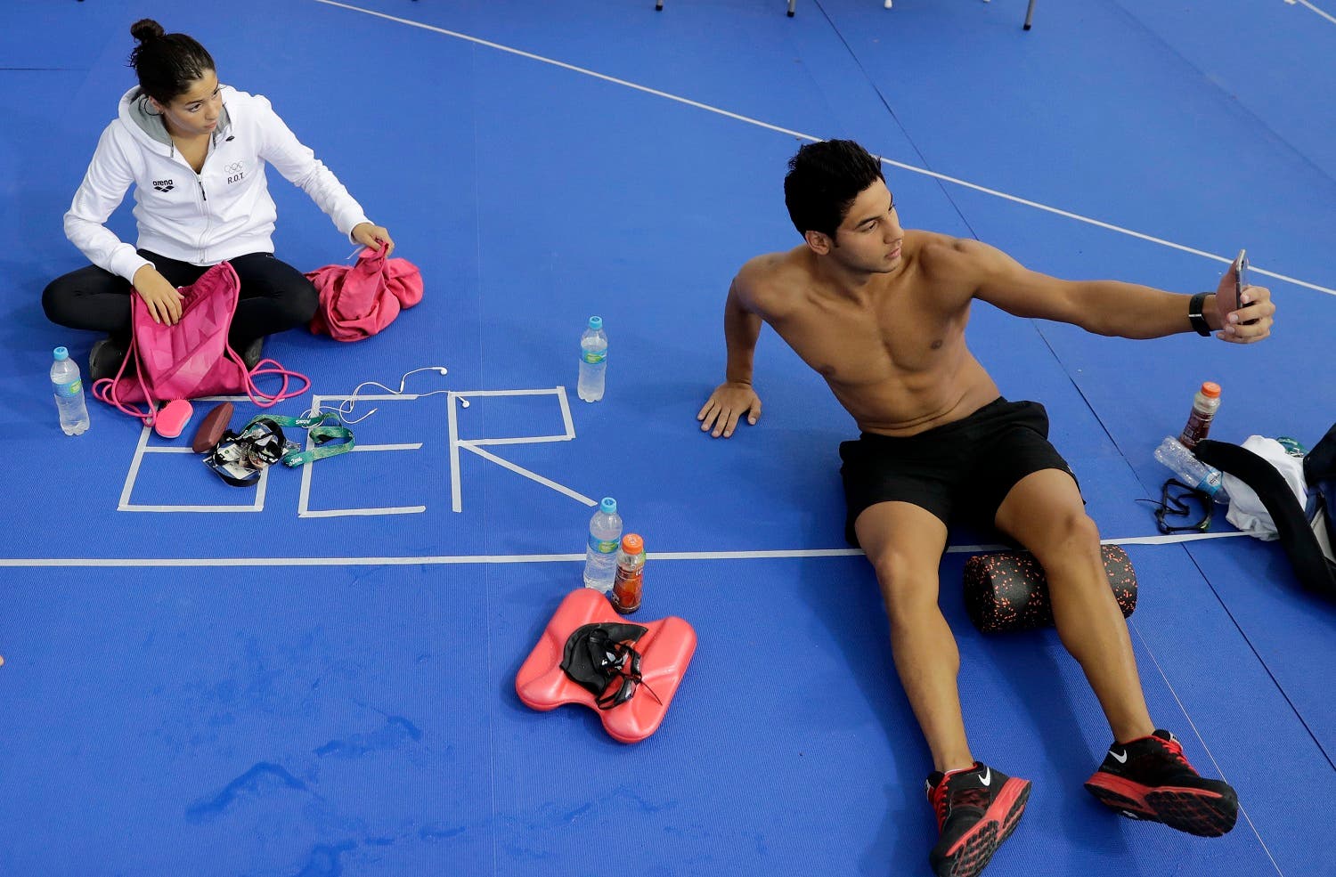 Swimmers on the Olympic refugee team Rami Anis, right, and Yusra Mardini pose for a selfie after practice at the Olympic Aquatics Stadium ahead of the Rio Olympics in Rio de Janeiro. (AP)
