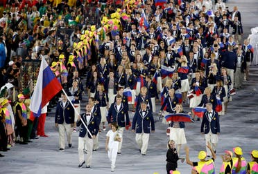 Flagbearer Sergey Tetyukhin (RUS) of Russia leads his contingent during the opening ceremony. REUTERS