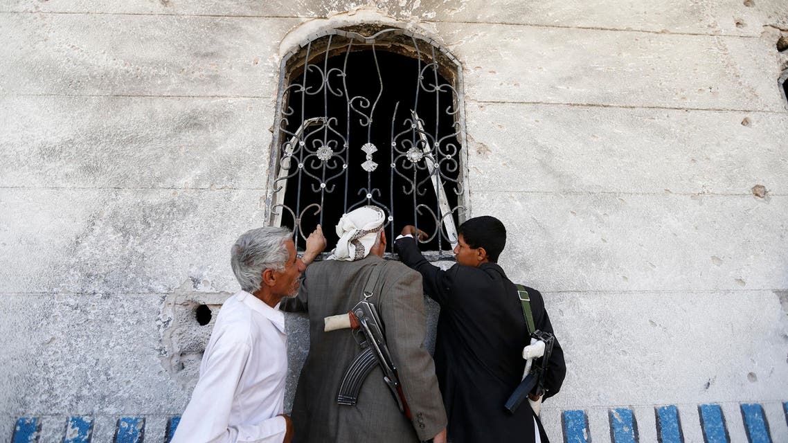 People look at damages caused by a police raid on a hideout of al Qaeda militants in the Arhab region, north of the Yemeni capital Sanaa May 27, 2014. Yemen's security forces on Sunday killed a senior al Qaeda leader wanted for attacks on local and foreign targets in Sanaa, the Yemeni government said, after the raid in which at least four other militants died. REUTERS