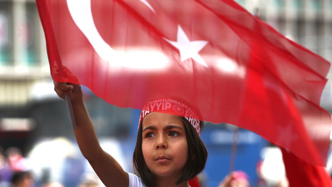 A Turkish girl wearing a headband bearing the name of Turkish president Recep Tayyip Erdogan waves her nation flags during a pro-government demonstration in front of the old parliament building, in Ankara, Turkey, Wednesday, July 20, 2016. The coup has led to public anger and calls for the government to reinstate capital punishment, while the state-run religious affairs body declared no religious rites would be performed for the coup plotters killed in the uprising. (AP)