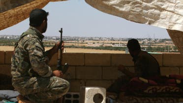 Fighters of the Syria Democratic Forces (SDF) sit in a look out position in the western rural area of Manbij, in Aleppo Governorate, Syria, June 13, 2016. REUTER