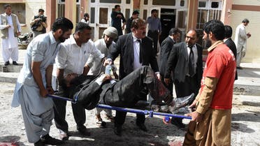 Pakistani lawyers use a stretcher to move an injured colleague after a bomb explosion at a government hospital premises in Quetta. (AFP)