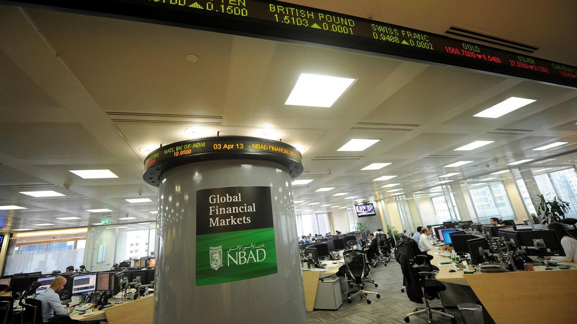 Employees are seen in the offices at the National Bank of Abu Dhabi (NBAD) headquarters, UAE, April 3, 2013. REUTERS