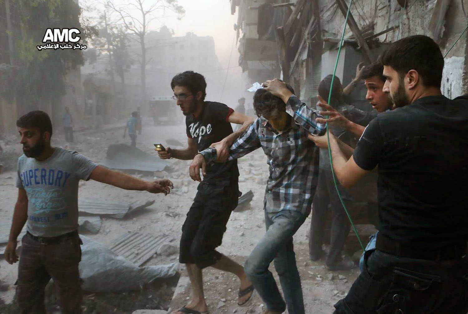 In this Sunday, July. 31, 2016 photo, provided by the Syrian anti-government activist group Aleppo Media Center (AMC), shows Syrians help an injured man, center, after airstrikes hit Aleppo, Syria (File Photo: Aleppo Media Center via AP)