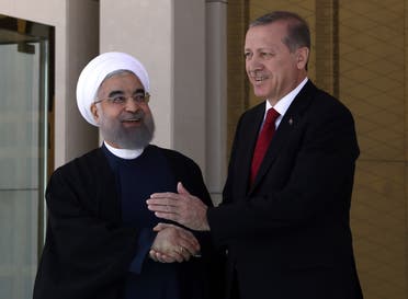 Turkey’s President Recep Tayyip Erdogan, right, and Iran’s President Hassan Rouhani shake hands during a welcome ceremony in Ankara, Turkey, on April 16, 2016. (AP)