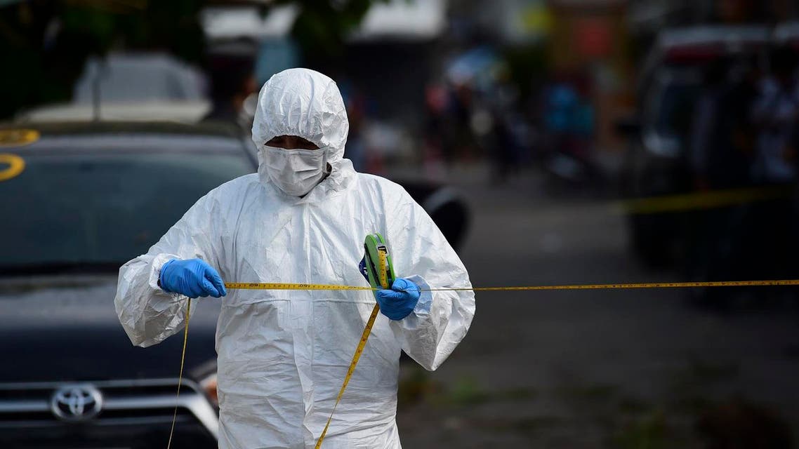 An investigation official collects evidence from the crime scene after a small bomb exploded in Hua Hin on August 12, 2016. (AFP)