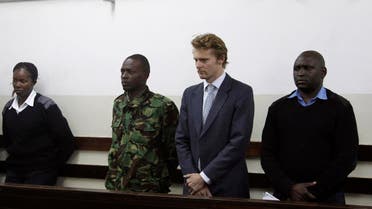 British national Jack Alexander Wolf Marrian (2nd R), flanked by police officers, appears in court in Nairobi on August 8, 2016, where he faces charges of trafficking 100 kilos of cocaine from Brazil to the port of Mombasa. A British sugar trader facing charges of trafficking cocaine worth $5.8 million was bailed on August 8, 2016 by a Nairobi court, with his lawyer declaring "the wrong man" was being targeted over a tampered shipment from Brazil. Jack Marrian, 31, from an aristocratic family has lived in east Africa since early childhood. He was charged on August 4, 2016 after police in the eastern port city of Mombasa seized 100 kilos (220 pounds) of cocaine hidden in a sugar consignment ordered by his firm. AFP