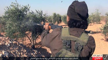 This image posted online on Monday, July. 18, 2016, by supporters of the Islamic State militant group on an anonymous photo sharing website, shows an Islamic State fighter fires his weapon during clashes with the Kurdish-led Syria Democratic Forces in Manbij, in Aleppo province, Syria. The Arabic caption on the photo reads, "Soldiers of the caliphate clash with Kurdish infidels in northern countryside of Manbij." (militant photo via AP)