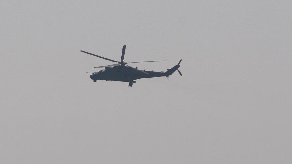  An Indian air force chopper on a reconnaissance mission flies over the Indian airbase in Pathankot, 430 kilometers (267 miles) north of New Delhi, India, Saturday, Jan. 2, 2016. At least four gunmen entered an Indian air force base near the border with Pakistan on Saturday morning and exchanged fire with security forces, leaving two of them dead, officials said. (AP Photo/Channi Anand)