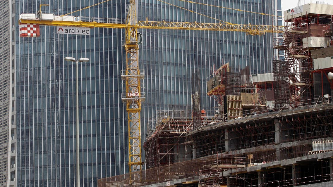 A worker operates a crane of the Arabtec construction company on a high-rise building in Dubai( File AP)