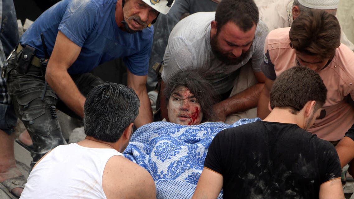 Men carry an injured girl after an airstrike on Aleppo's rebel held Kadi Askar area, Syria July 8, 2016. REUTERS