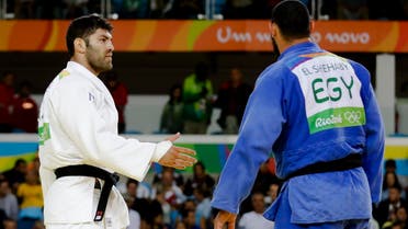 Egypt's Islam El Shehaby, blue, declines to shake hands with Israel's Or Sasson, white, after losing during the men's over 100-kg judo competition at the 2016 Summer Olympics in Rio de Janeiro, Brazil, Friday, Aug. 12, 2016. (AP)