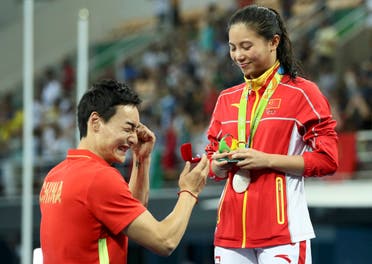 He Zi (CHN) of China recieves a marriage proposal from Olympic diver Qin Kai (CHN) of China after the medal ceremony. She accepted Qin's proposal. REUTERS