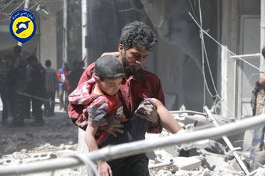 In this file photo taken on May 31, 2016 provided by the Syrian Civil Defense Directorate in Liberated Province of Aleppo, which has been authenticated based on its contents and other AP reporting, shows Syrian man carries an injured boy, in Aleppo, Syria. ap