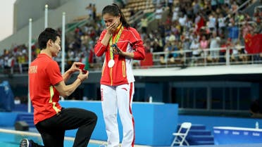 He Zi (CHN) of China recieves a marriage proposal from Olympic diver Qin Kai (CHN) of China after the medal ceremony. She accepted Qin's proposal. REUTERS