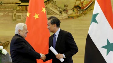 China's Foreign Minister Wang Yi (R) shakes hands with Syria's Foreign Minister Walid al-Moualem during a joint news conference after a meeting at the Ministry of Foreign Affairs in Beijing, China, December 24, 2015. REUTERS