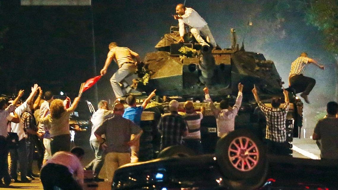 A tank moves into position as Turkish people attempt to stop them, in Ankara, Turkey, early Saturday, July 16, 2016. Members of Turkey's armed forces said they had taken control of the country Friday as explosions, gunfire and a reported air battle between loyalist forces and coup supporters erupted in the capital. President Erdogan remained defiant and called on people to take to the streets to show support for his embattled government. (AP Photo)