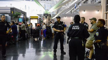 Members of the Port Authority Police Department stand guard at Terminal 8 at John F. Kennedy airport in the Queens borough of New York City, early August 15, 2016. REUTERS