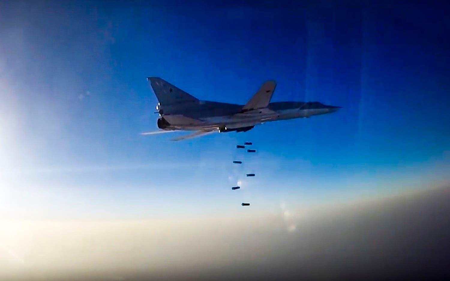 In this frame grab provided by Russian Defence Ministry press service, Russian long range bomber Tu-22M3 flies during an air strike over Aleppo region of Syria on Tuesday, Aug. 16, 2016. Russia's Defense Ministry said on Tuesday Russian warplanes have taken off from a base in Iran to target Islamic State fighters in Syria. (Russian Defence Ministry Press Service photo via AP)