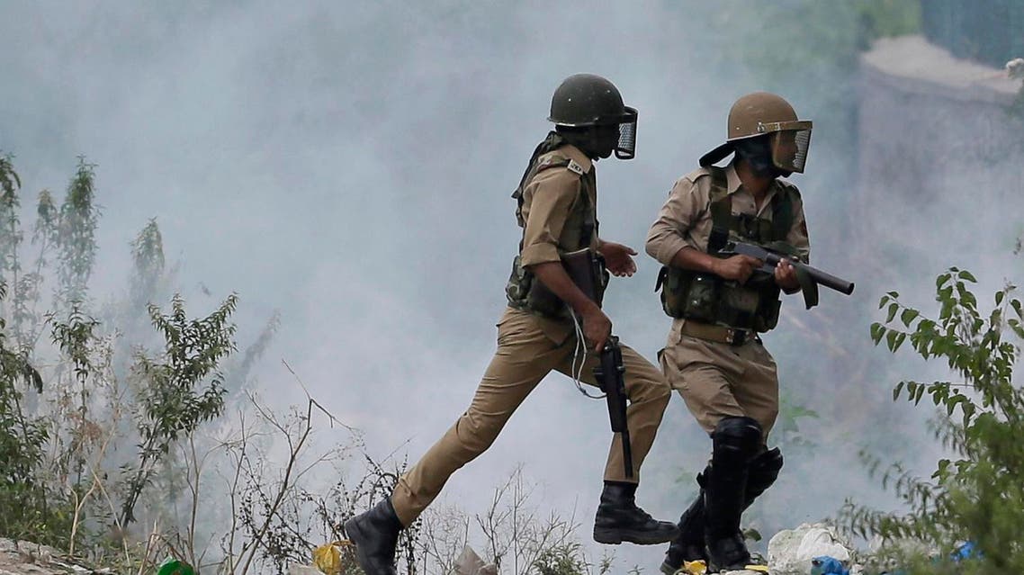 Indian policemen chase Kashmiri Muslim protesters in Srinagar, Indian-controlled Kashmir AP