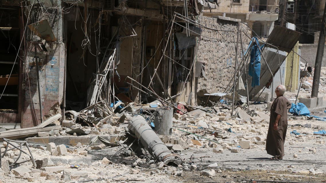 A resident of the Tariq al-Bab neighbourhood of Aleppo, inspects the damage caused by reported air raids that targetted rebel-held areas in the northern city on August 16, 2016. (AFP)