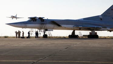A Russian Tu-22M3 bomber stands on the tarmac while another plane lands at an air base near Hamedan, Iran. (AP)