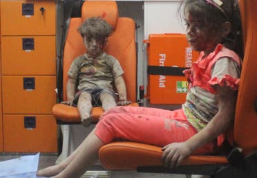 Five-year-old Omran Daqneesh, with bloodied face, sits with his sister inside an ambulance after they were rescued following an airstrike in the rebel-held al-Qaterji neighbourhood of Aleppo. (Reuters)