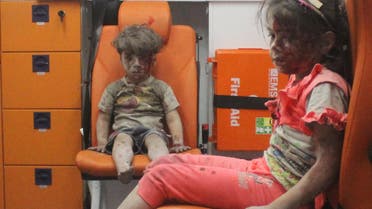 Five-year-old Omran Daqneesh, with bloodied face, sits with his sister inside an ambulance after they were rescued following an airstrike in the rebel-held al-Qaterji neighbourhood of Aleppo. (Reuters)