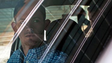 American Olympic swimmers Gunnar Bentz, left, and Jack Conger, in backseat, sit inside a car outside a police station where they were going to provide testimony in Rio de Janeiro, Thursday, Aug. 18, 2016. (AP)